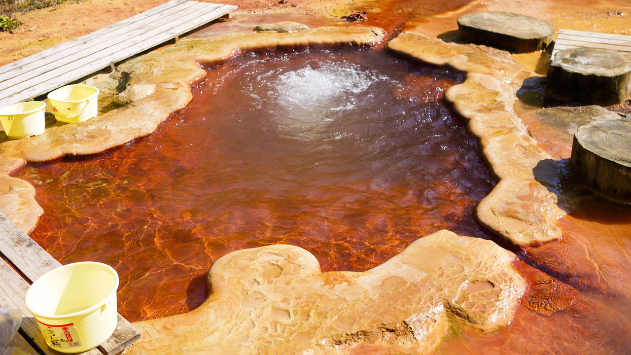 beautiful outdoor onsen with red water