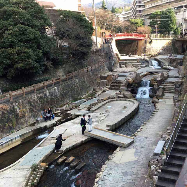 park with a river running under it in japan