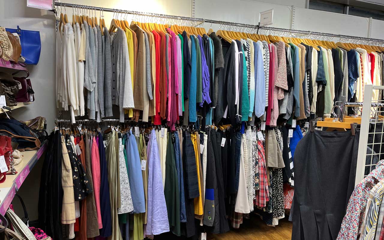 photo of a rack of secondhand clothes in a store