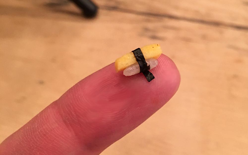 tiny sushi on a finger